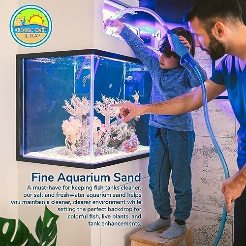 Adult and child cleaning a fish tank with aquarium sand.