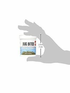 Hand holding a container of Bug Bites Tropical Formula.