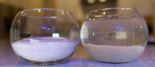 Two glass bowls with sand inside on a reflective surface.